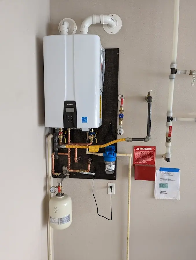 Professional plumber installing copper piping in a Red Bay home